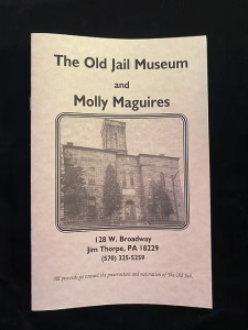 Booklet titled “The Old Jail Museum and Molly Maguires” with a black and white photo of the museum building.